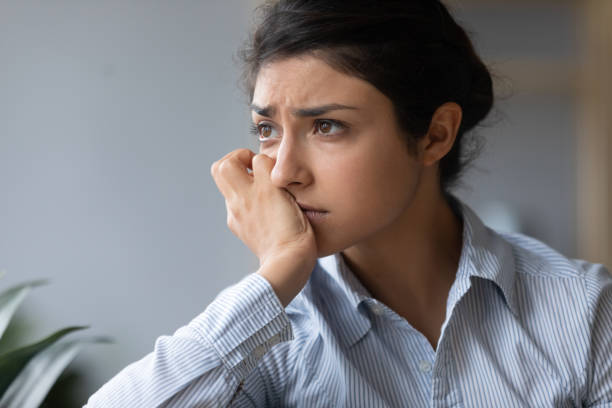 istock Sad melancholic indian woman looking away thinking of problems alone 1198252606