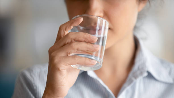 istock Healthy young lady drinking fresh clean water, close up view 1198252618