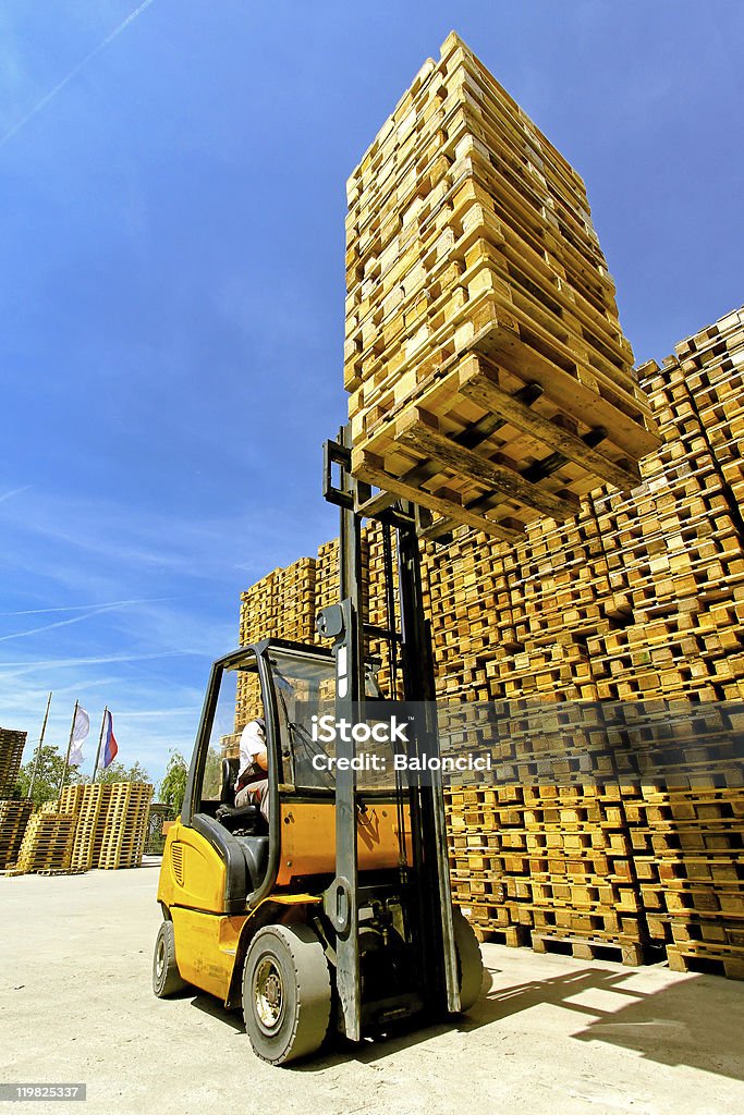 Forklift load Forklift operator loading bunch of euro pallets. Color Image Stock Photo