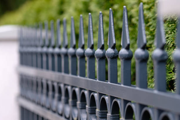 istock Elegant grey iron fence with white pillars 1198253832