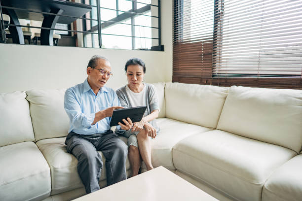 istock Modern senior couple using digital tablet together 1198253952