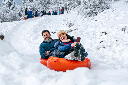 Sledding tubes on snowy hill in winter