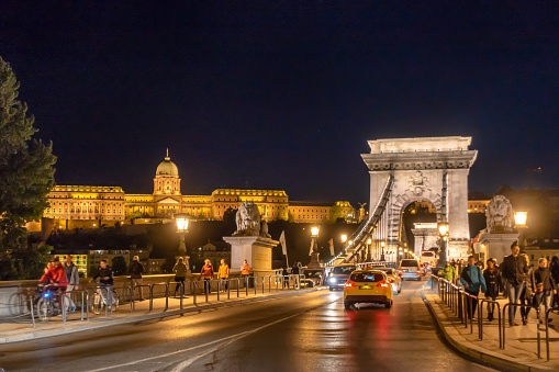 april 16, 2017 - Budapest, Hungary: tourists in Chain Bridge and Royal Palace at night, Budapest, Hungary