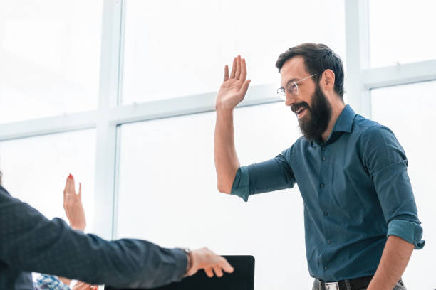 istock business colleagues giving each other a high five 1198257467