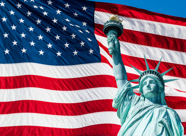 istock Statue of Liberty and US Flag 1198260394