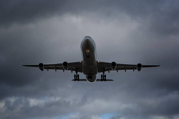 istock Low-angle view of a landing airplane 1198260682