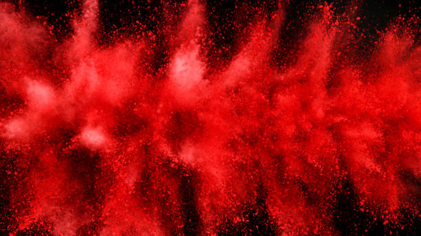 istock Explosion of red powder isolated on black background 1198260778