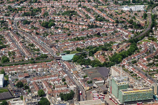 Aerial view of the London district of Hounslow East with the Piccadilly Line tube station and Hounslow Bus Station in the middle of the image.  Sunny summer day.