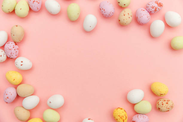 istock Happy Easter concept. Easter candy chocolate eggs and jellybean sweets isolated on trendy pastel pink background. Simple minimalism flat lay top view copy space 1198262789