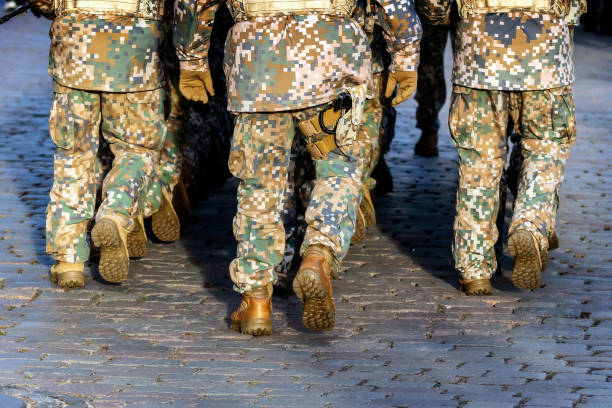 istock Abstract background on military theme. Soldier rank, legs, close-up. Rear view. - image 1198262964