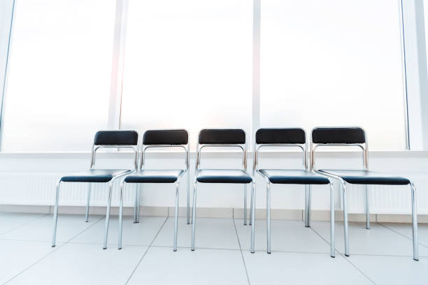 istock row of empty chairs in the office corridor 1198263250