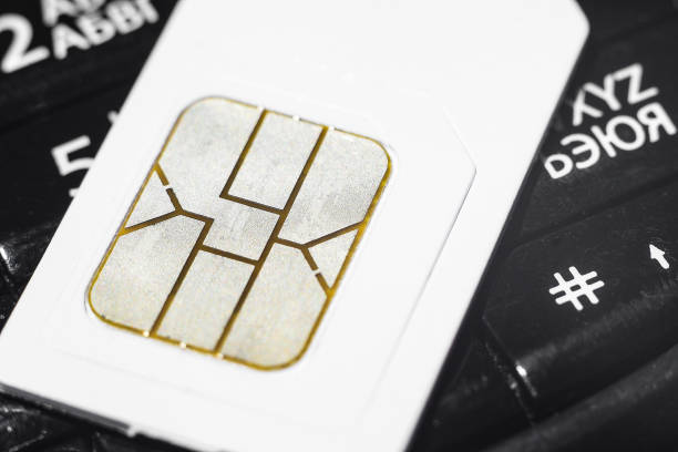 istock Mobile sim card on phone keyboard 1198265296