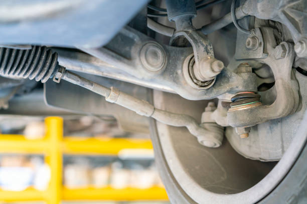 car bottom view for ball joint and control arm power steering rack suspension system and etc of saloon or sedan car at garage lift up for maintenance