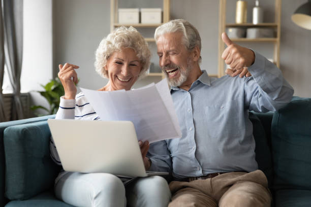 istock 70s spouses check documents feels happy about pay debt off 1198265935
