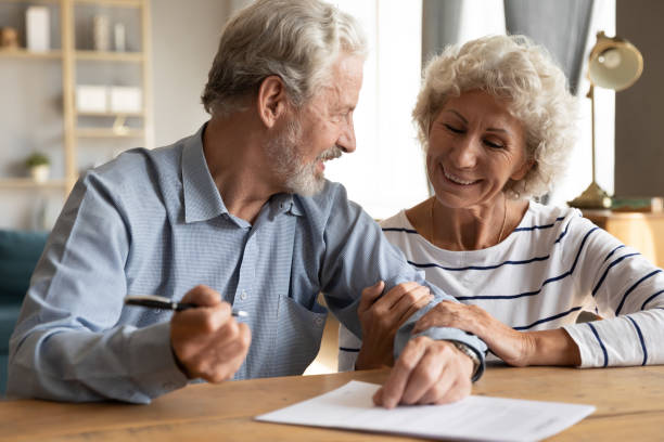 istock 70s couple discuss agreement ready to sign contract 1198266006