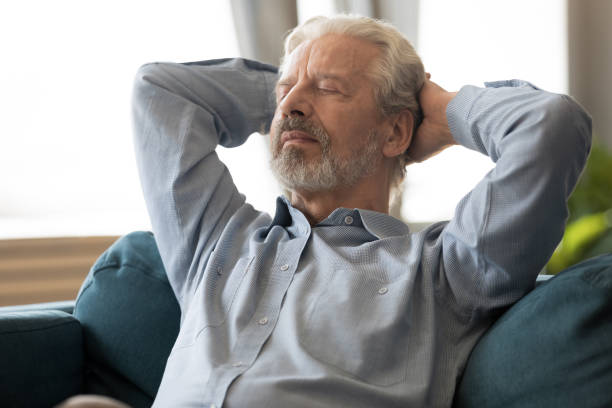 istock Senior man leaned on couch put hands behind head resting 1198266028