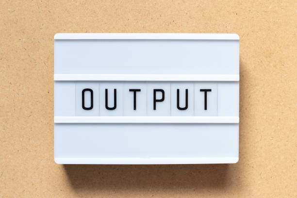 istock White lightbox with word output on wood background 1198267083