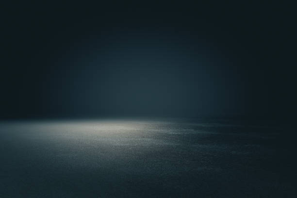 istock Abstract spacious place with dark wall, granular floor and spot light from above. 1198267919