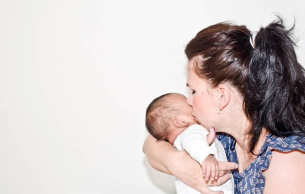 istock Mother cuddling a new-born child 1198269334