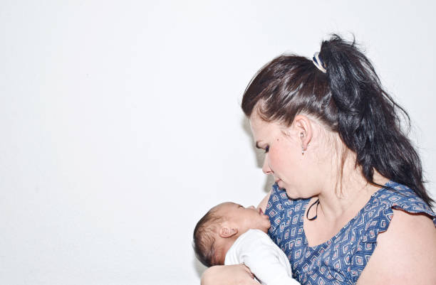 istock Mother cuddling a new-born child 1198269365