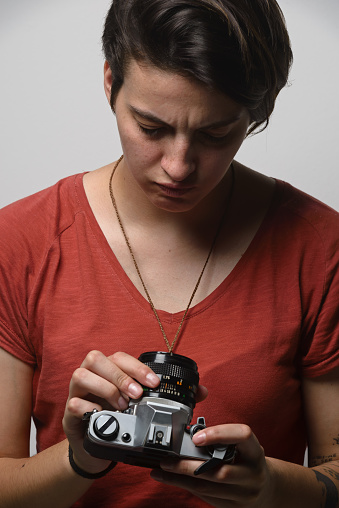 Portrait of a young brazilian woman holding photographic equipment