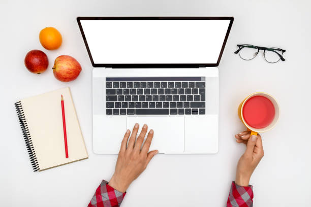 istock Top view of beautiful woman 's hands using laptop placed on white desktop. Flat lay 1198271446