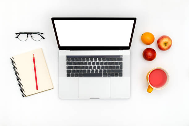 Opened laptop with isolated screen on white desk. Flat lay. Top view