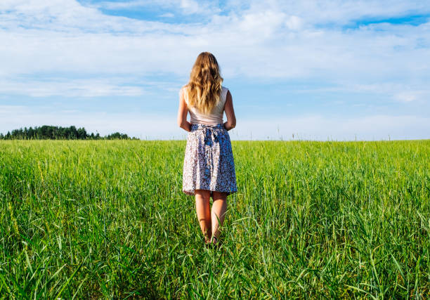 istock Young woman on a wheat field with sunlight 1198273828
