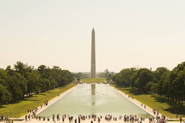 Washington monument obelisk A landscape view of the obelisk at Washington DC washington monument reflecting pool stock pictures, royalty-free photos & images