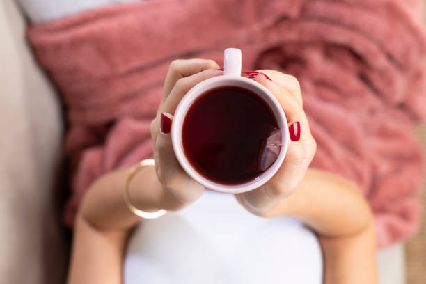 istock Young woman having morning tea in sofa. 1198276303