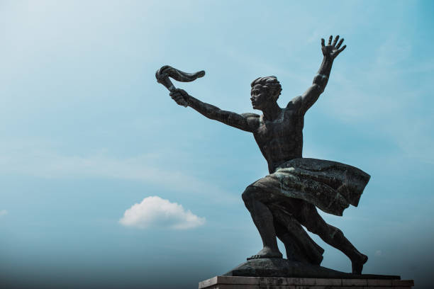 istock Liberty Monument Budapest, side statue torch-bearer and clear blue sky 1198276324