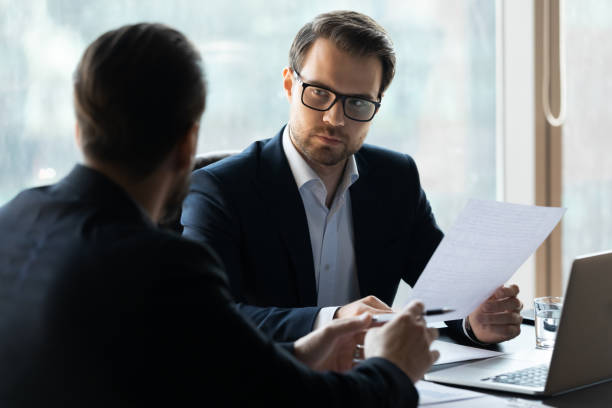 istock Serious businessmen discuss cooperation at office meeting 1198278176