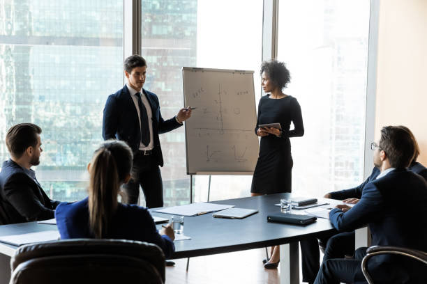 istock Diverse speakers make flip chart presentation at meeting 1198278226