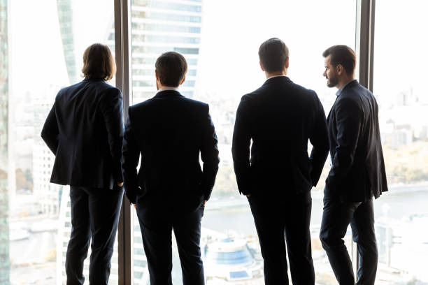 istock Back view of successful businessmen talk in office 1198278251