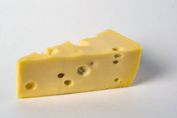 istock Delicious piece of cheese on white background 1198279183