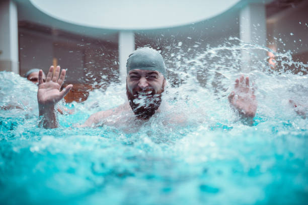 istock Friends Splashing In Indoors Swimming Pool 1198280202