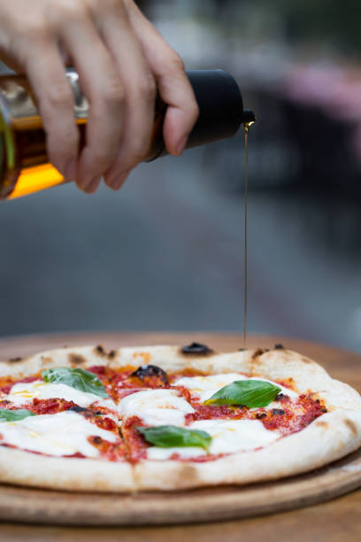 istock a delicious pizza with pouring olive oil 1198280580