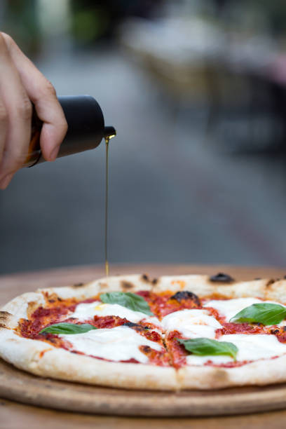 istock a delicious pizza with pouring olive oil 1198280582