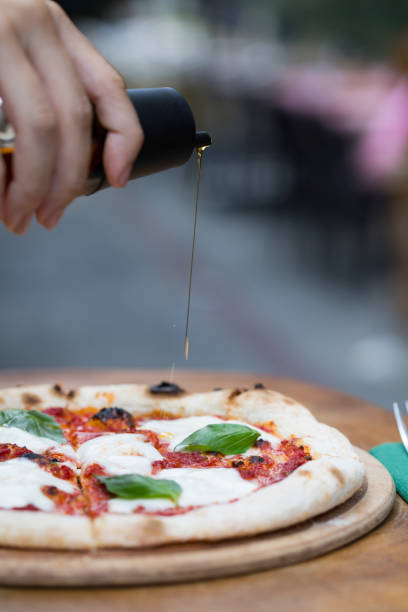 istock a delicious pizza with pouring olive oil 1198280583