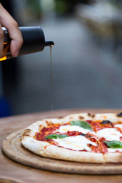 istock a delicious pizza with pouring olive oil 1198280959