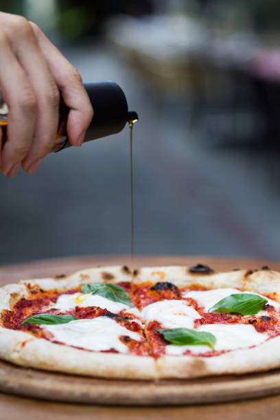 istock a delicious pizza with pouring olive oil 1198281143
