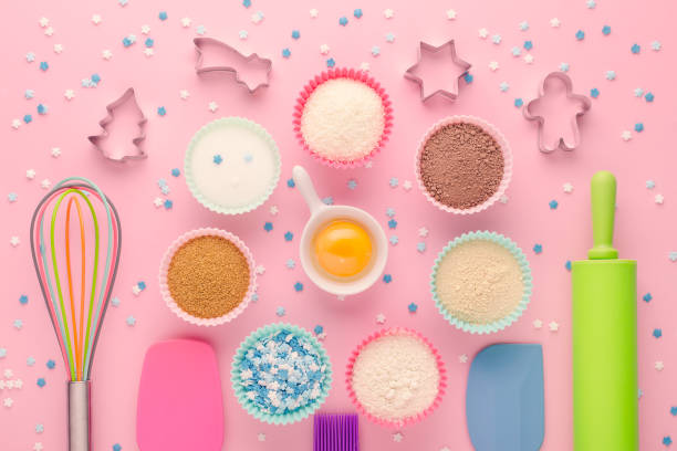istock ingredients for baking and kitchen tools with cookie cutter on pink background, flat lay 1198281196