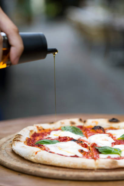 istock a delicious pizza with pouring olive oil 1198281254