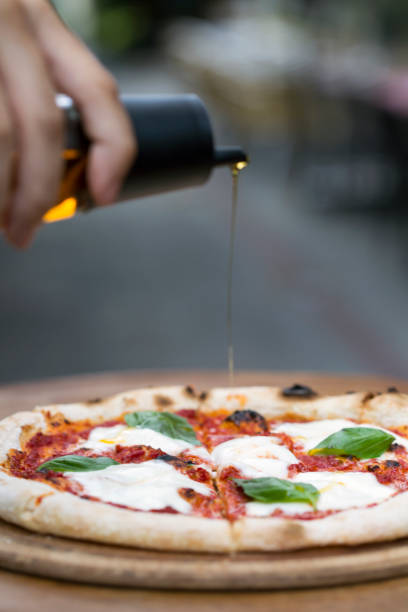 istock a delicious pizza with pouring olive oil 1198281257