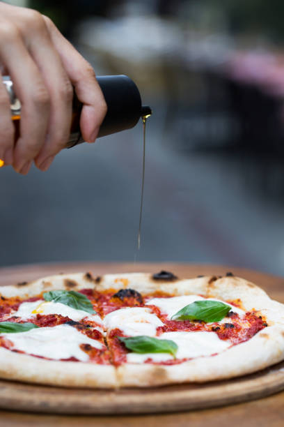 istock a delicious pizza with pouring olive oil 1198281258