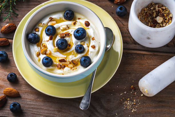 istock Greek yogurt with fresh blueberries, drizzled honey and almonds. 1198286894