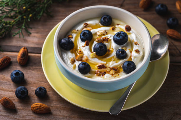 istock Greek yogurt with fresh blueberries, drizzled honey and almonds. 1198287040