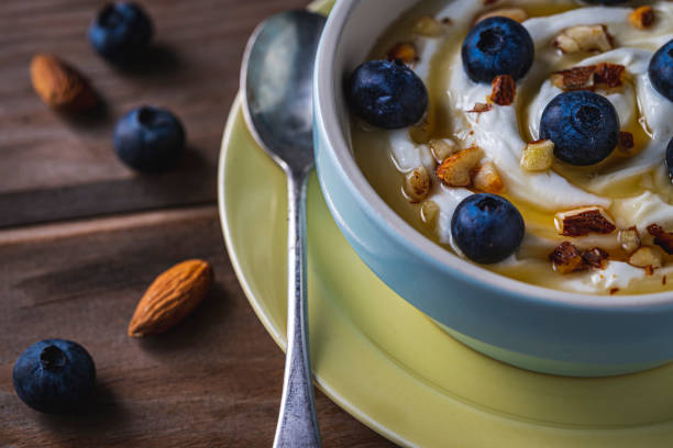 istock Greek yogurt with fresh blueberries, drizzled honey and almonds. 1198287071