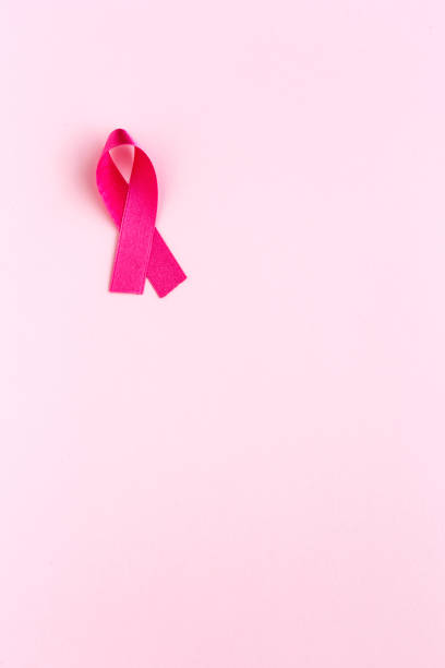 istock Pink ribbon on a colored background. Cancer 1198287122