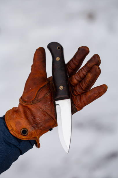 istock bushcraft knives and leather gloves 1198287189